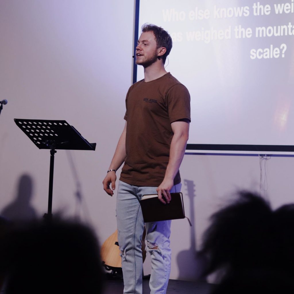 Josh Terradez teaching on stage with a Bible in his hand